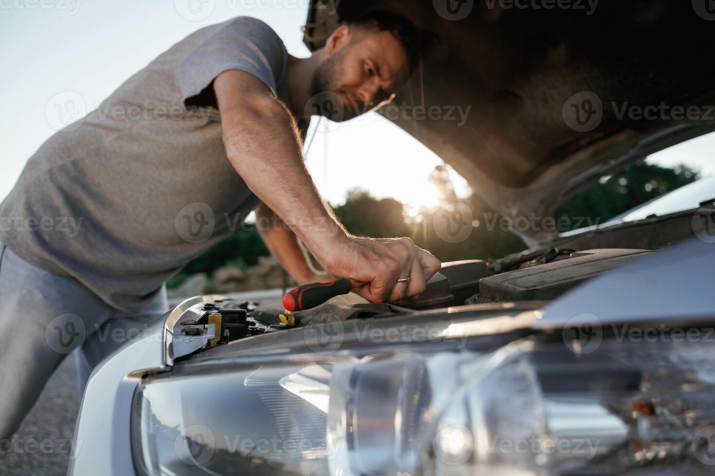 Breakdown, ,hood is opened,,,, repairing. Man is with his car outdoors photo