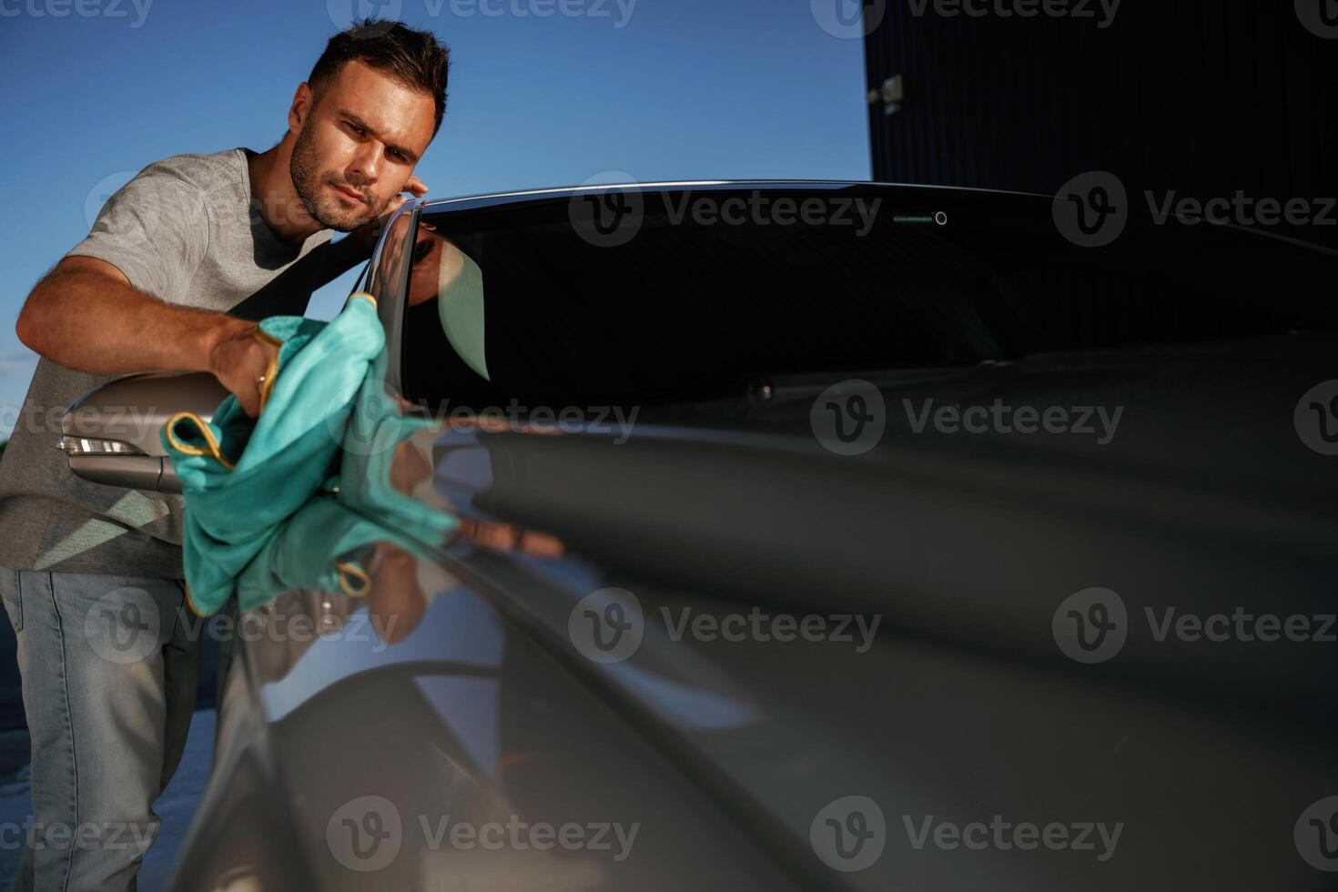 Job of car washing. Man,, is, with ,automobile outdoors photo