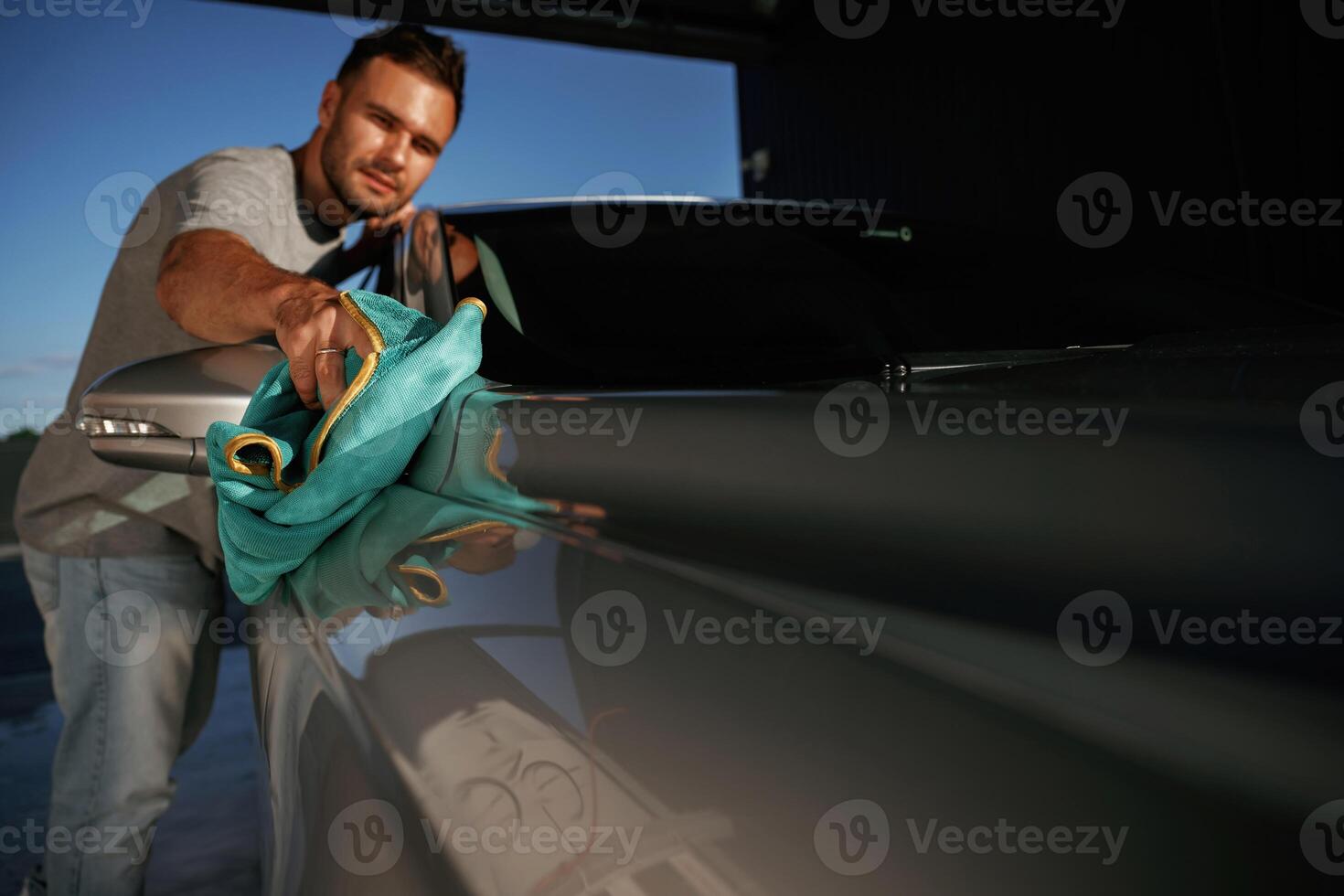 Job of ,car washing. Man ,is, with, automobile outdoors photo