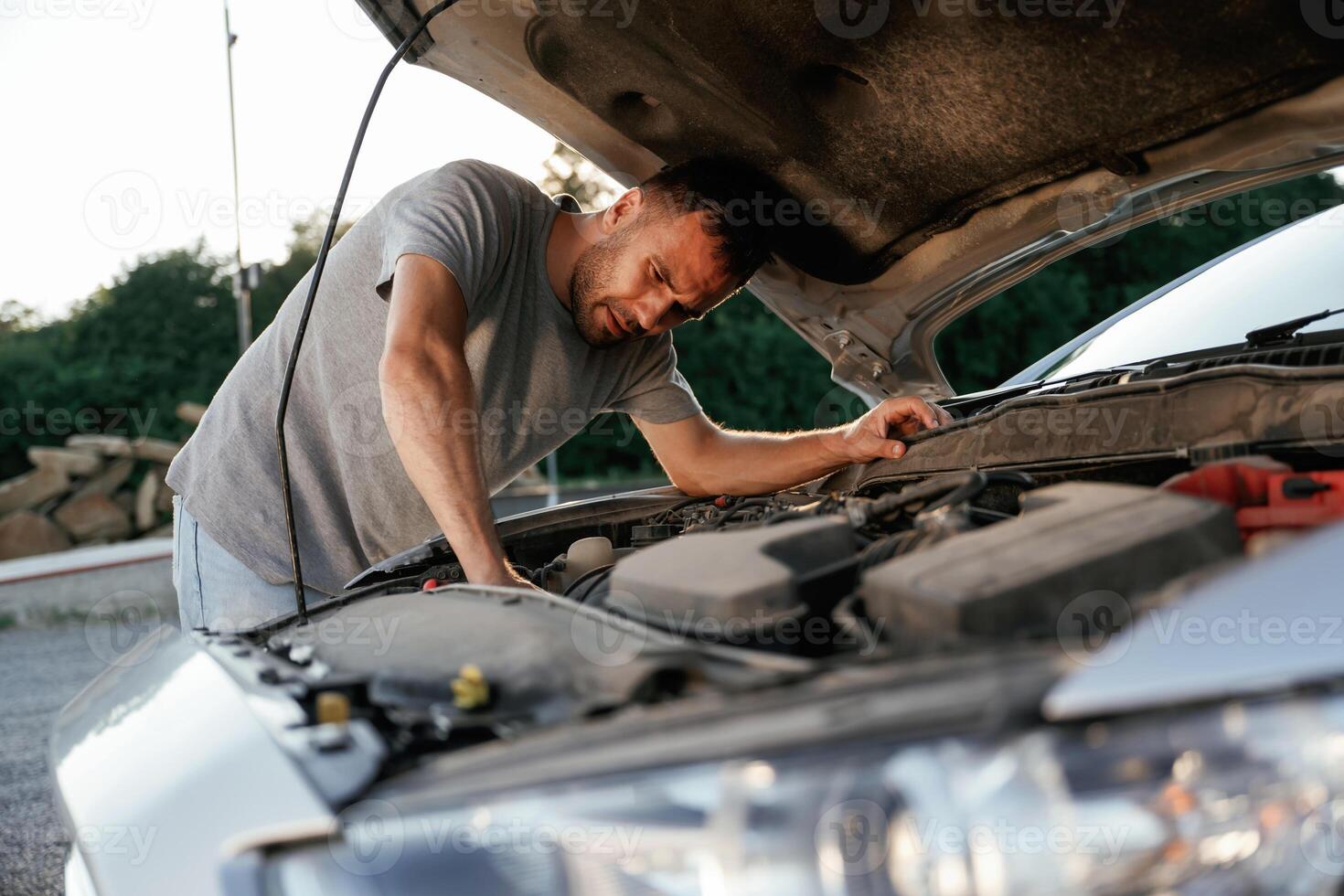 Problem, fixing and repairing the broken automobile. Man is with his car outdoors photo