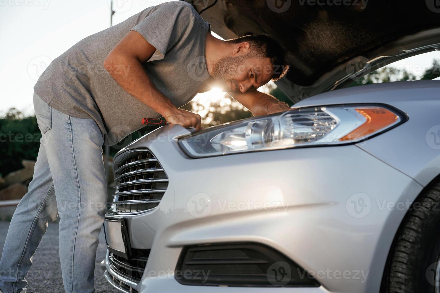 Breakdown, hood ,is, opened, repairing. Man is with his car outdoors photo