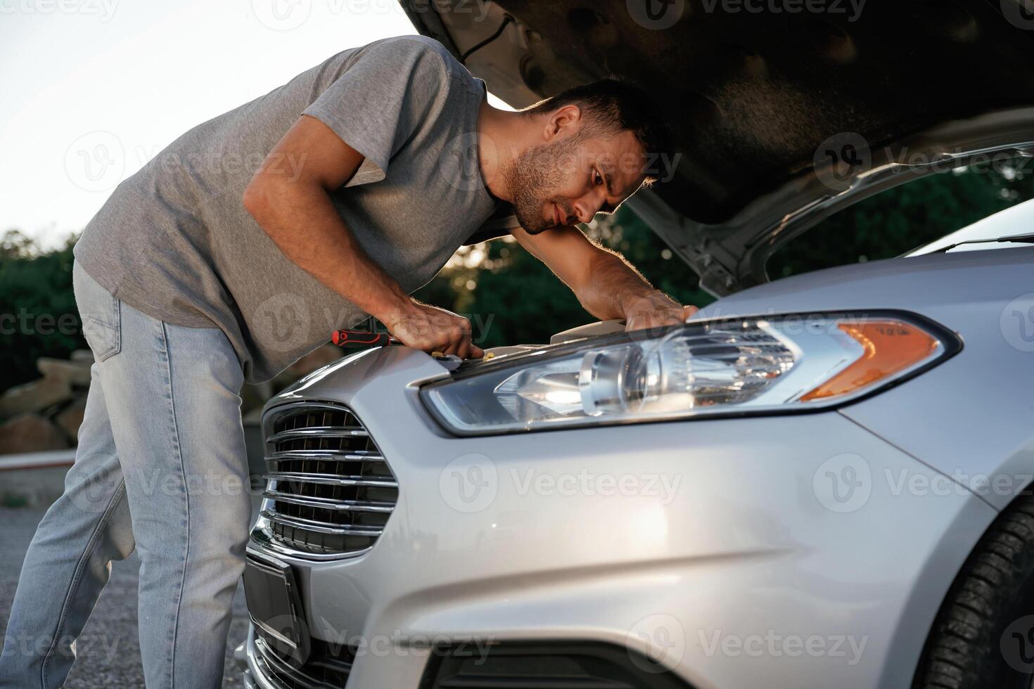 Breakdown, hood is opened,,, repairing. Man is with his car outdoors photo