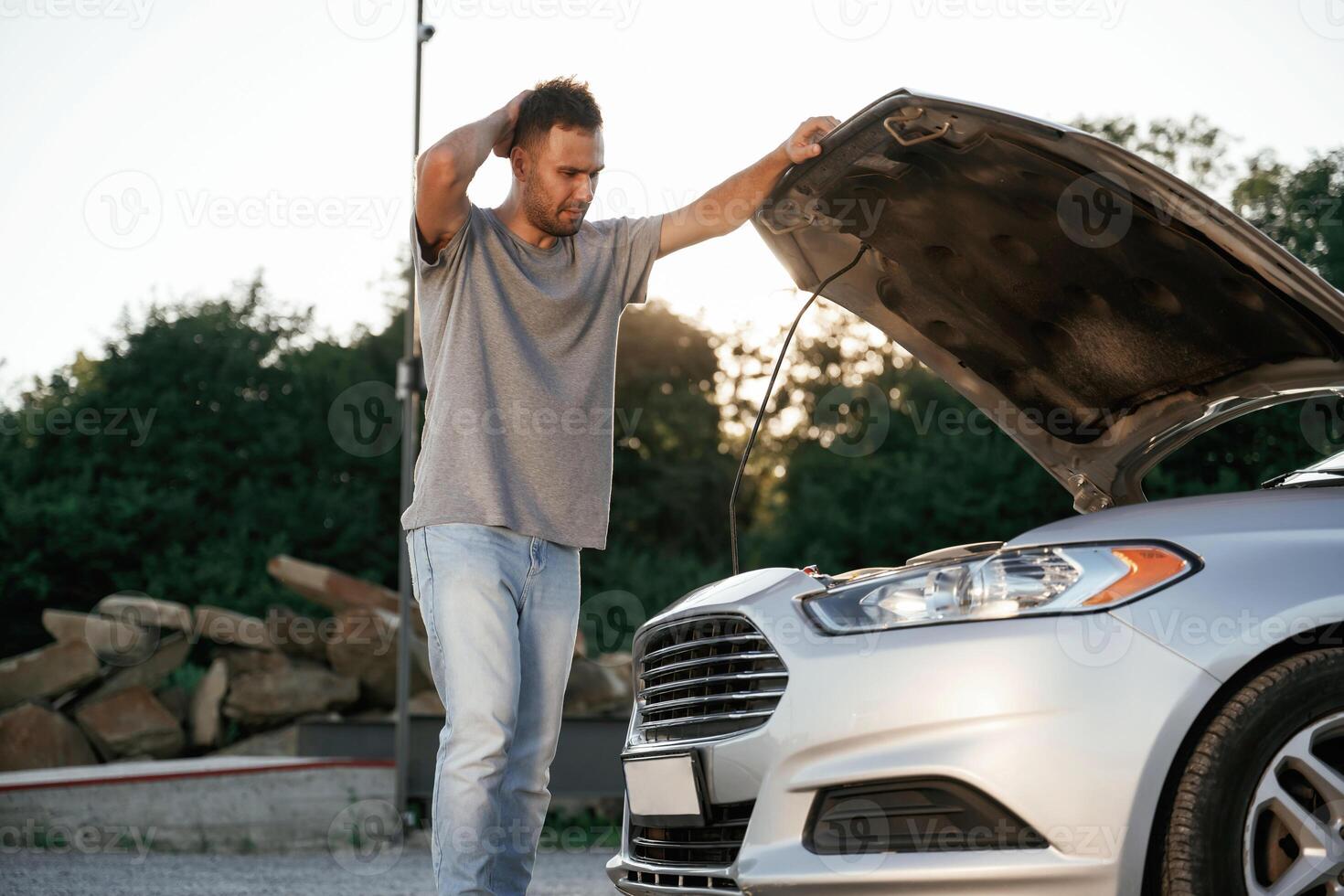 Problem, fixing ,and repairing the broken automobile. Man is with his car outdoors photo