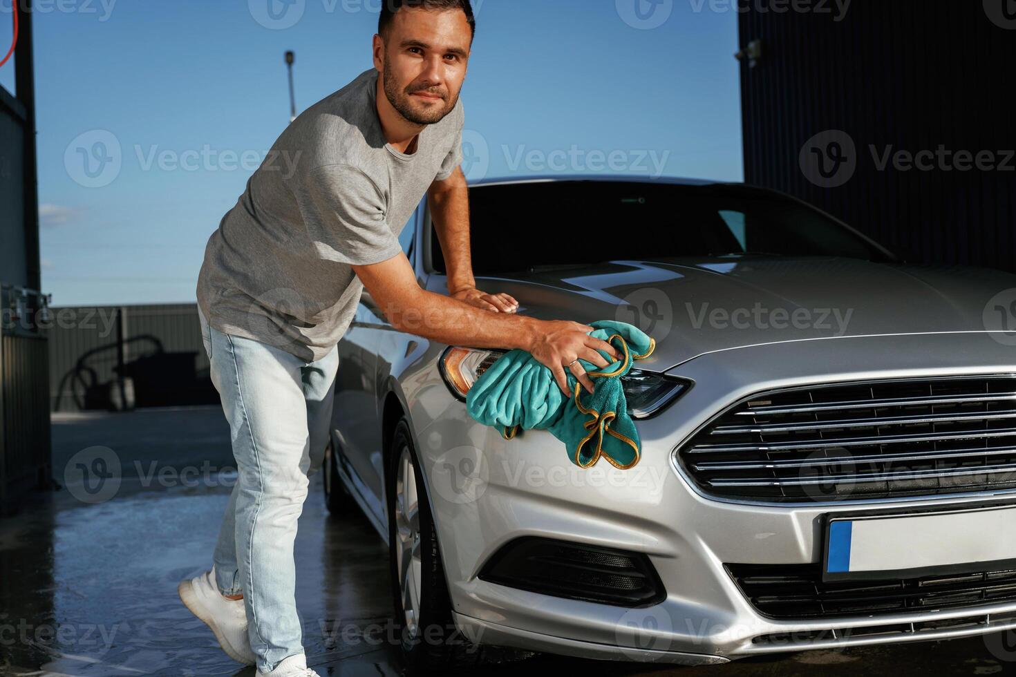 Business ,,of car washing, polishing. Man is with automobile outdoors photo
