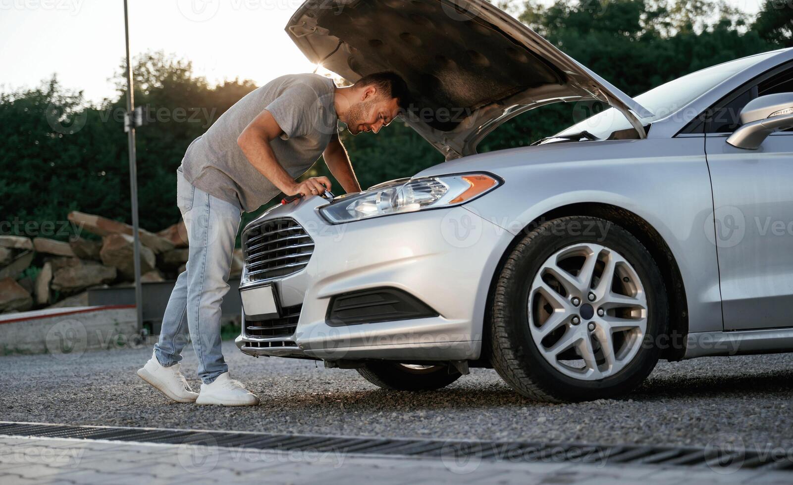 Problem,, fixing and repairing the broken automobile. Man is with his car outdoors photo