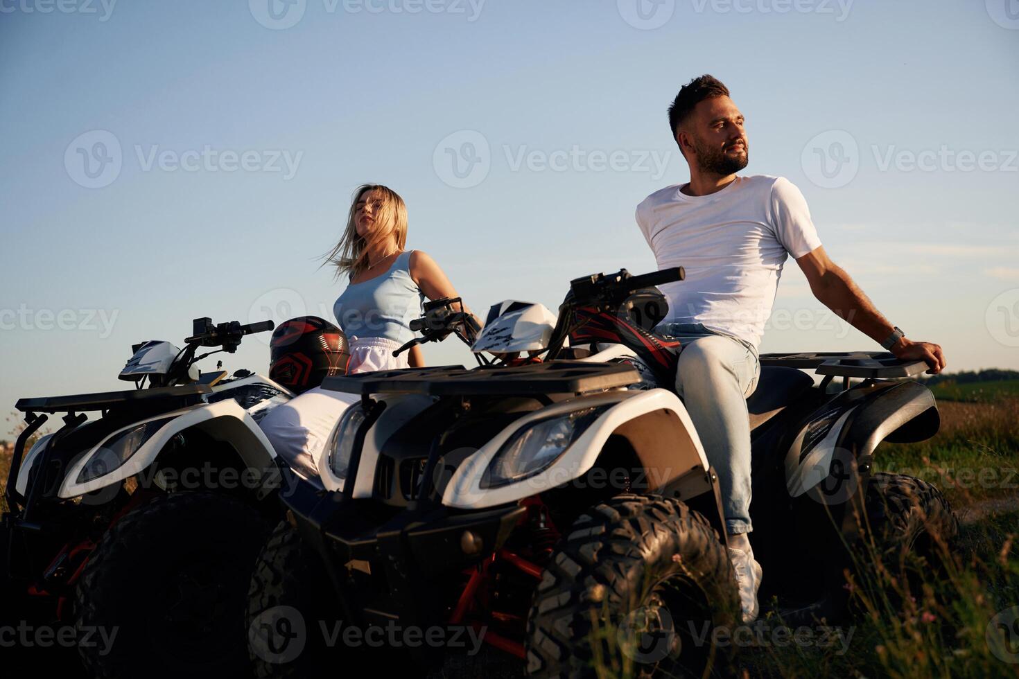 Sitting, taking, a, break. Man and woman are on ATV outdoors photo