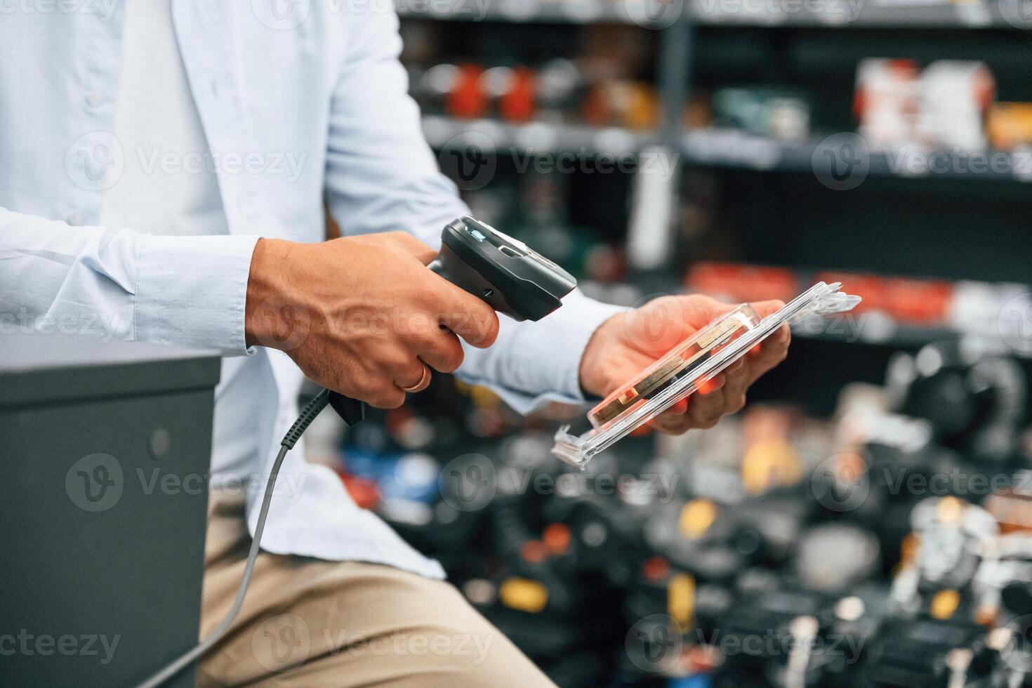 Cashier is ,at work. Man is in the hardware shop photo