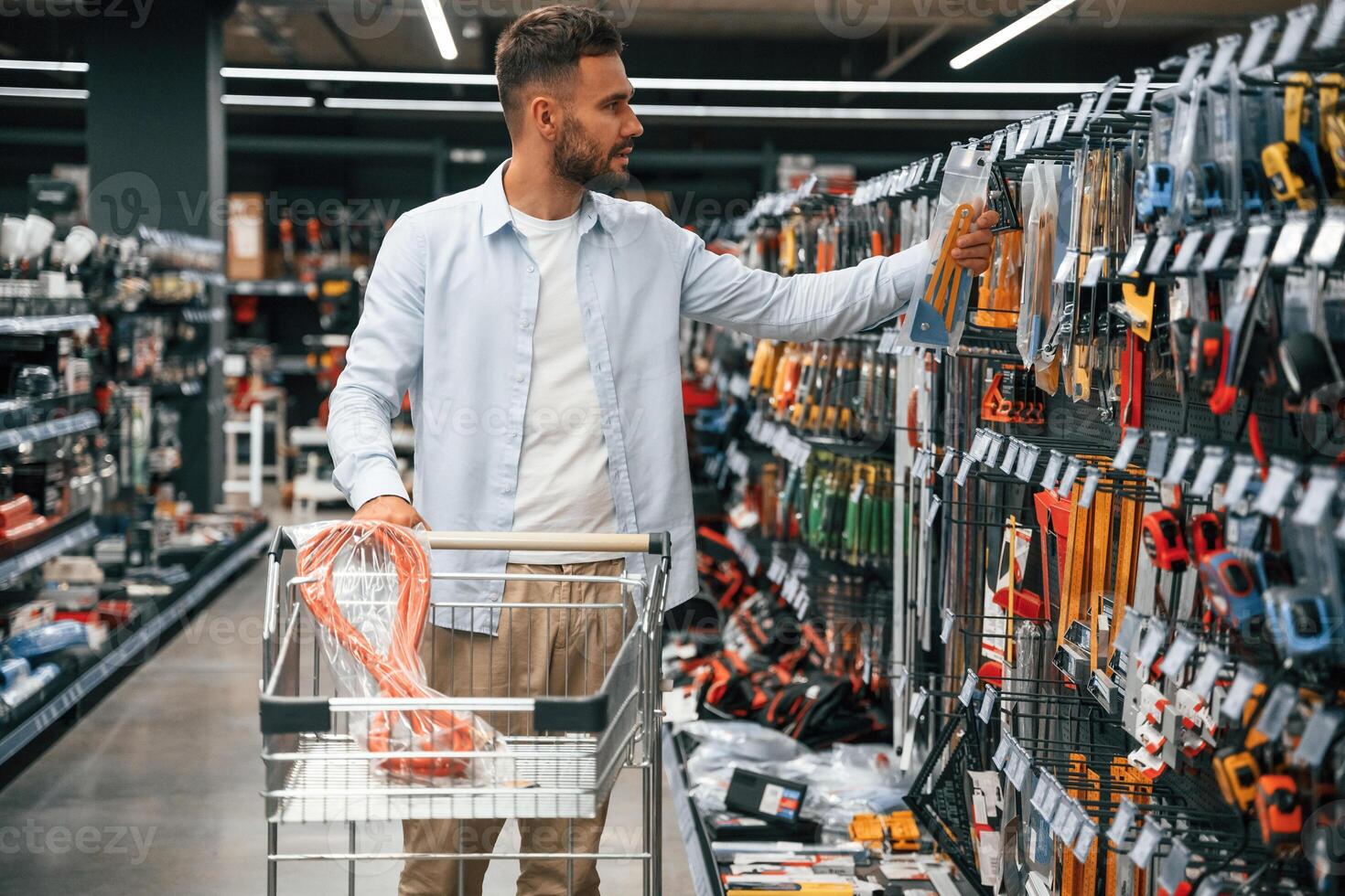 Looking for the, nice ,hardware. Man is in the hardware shop photo
