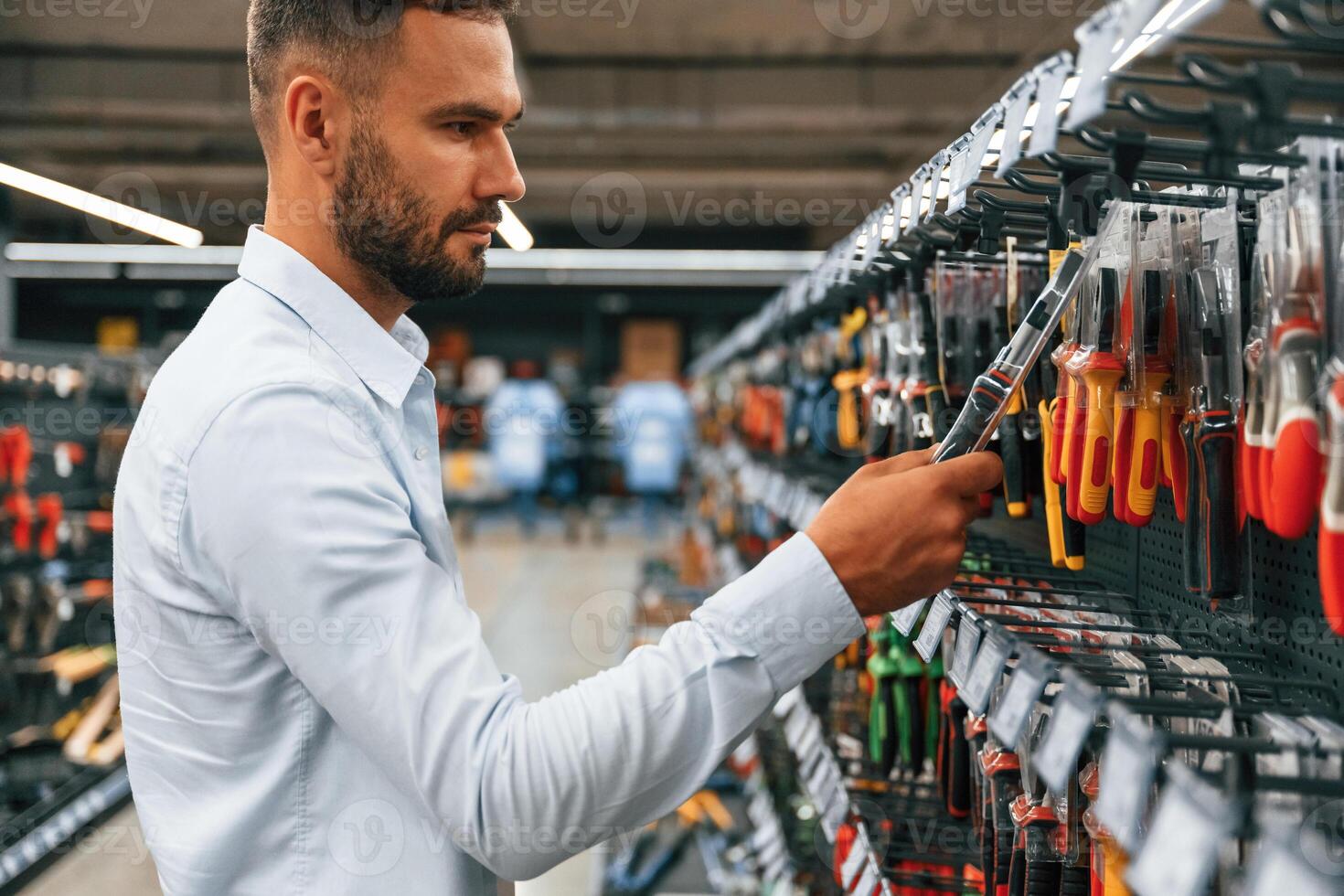 Searching for, the tools. Man is in the hardware shop photo