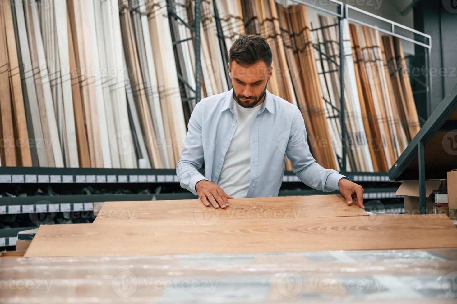 Parquet,, choosing.,, Man is in the hardware shop photo