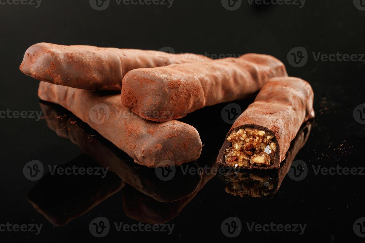 Crispy, and sweet chocolate bars on black background photo