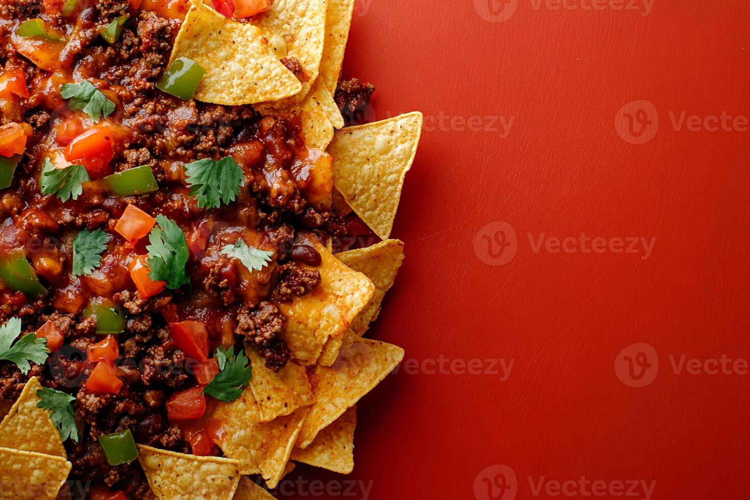 Tortilla chips with meat and vegetables on a red background photo