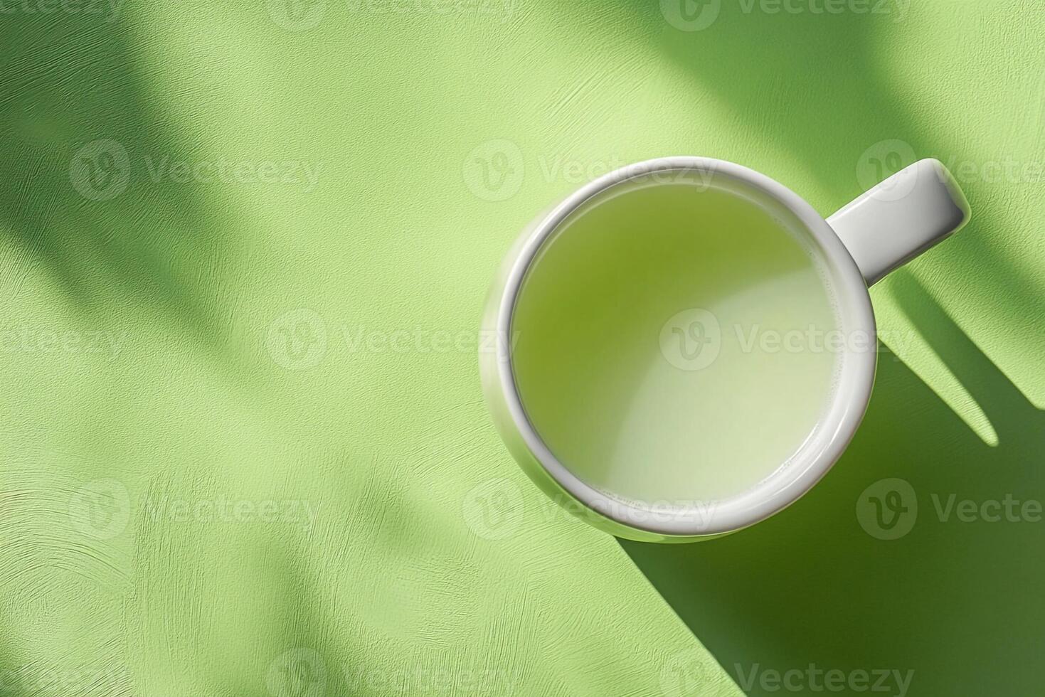 A cup of green tea on a bright green background photo
