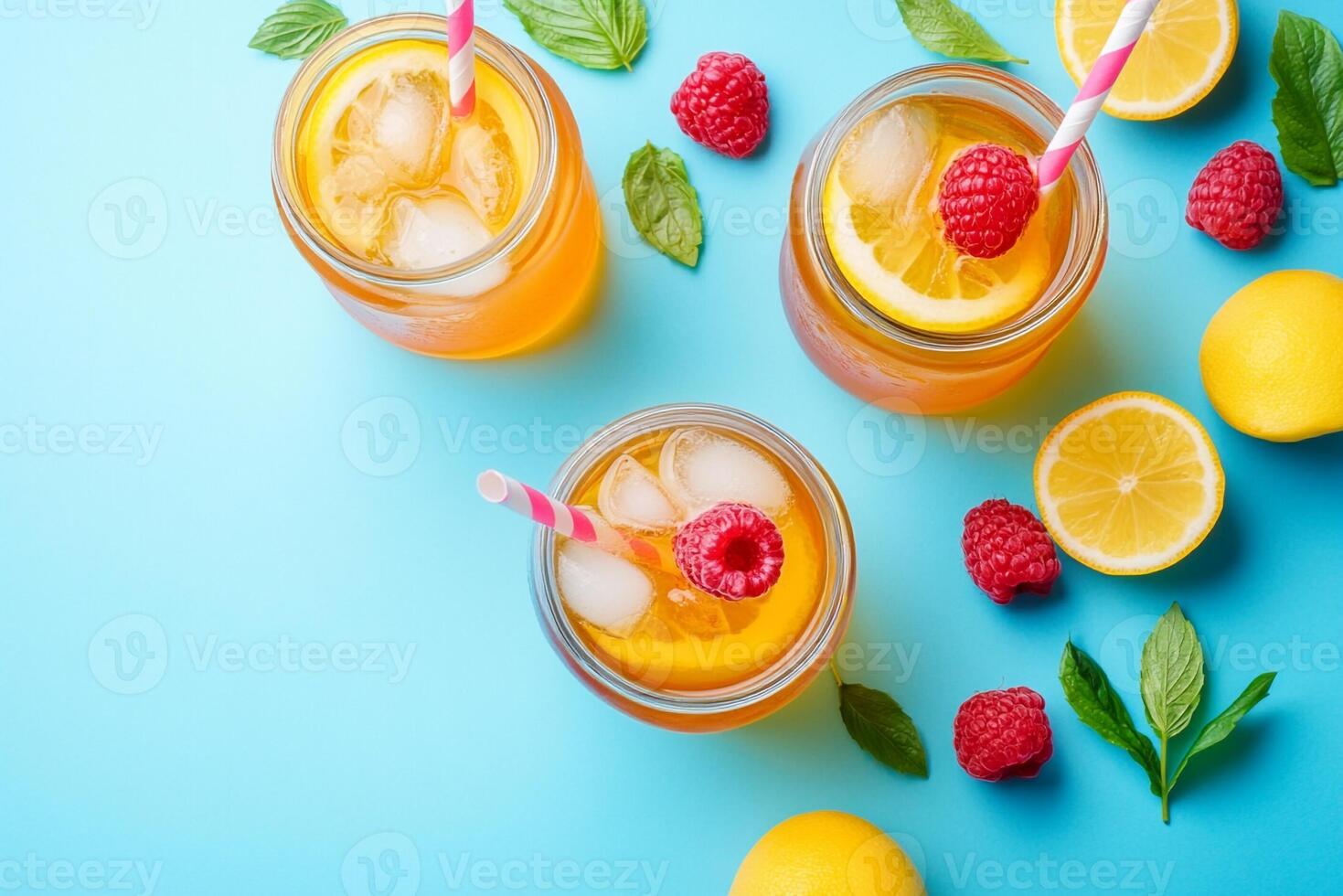 Three jars of lemonade with raspberries and mint leaves photo