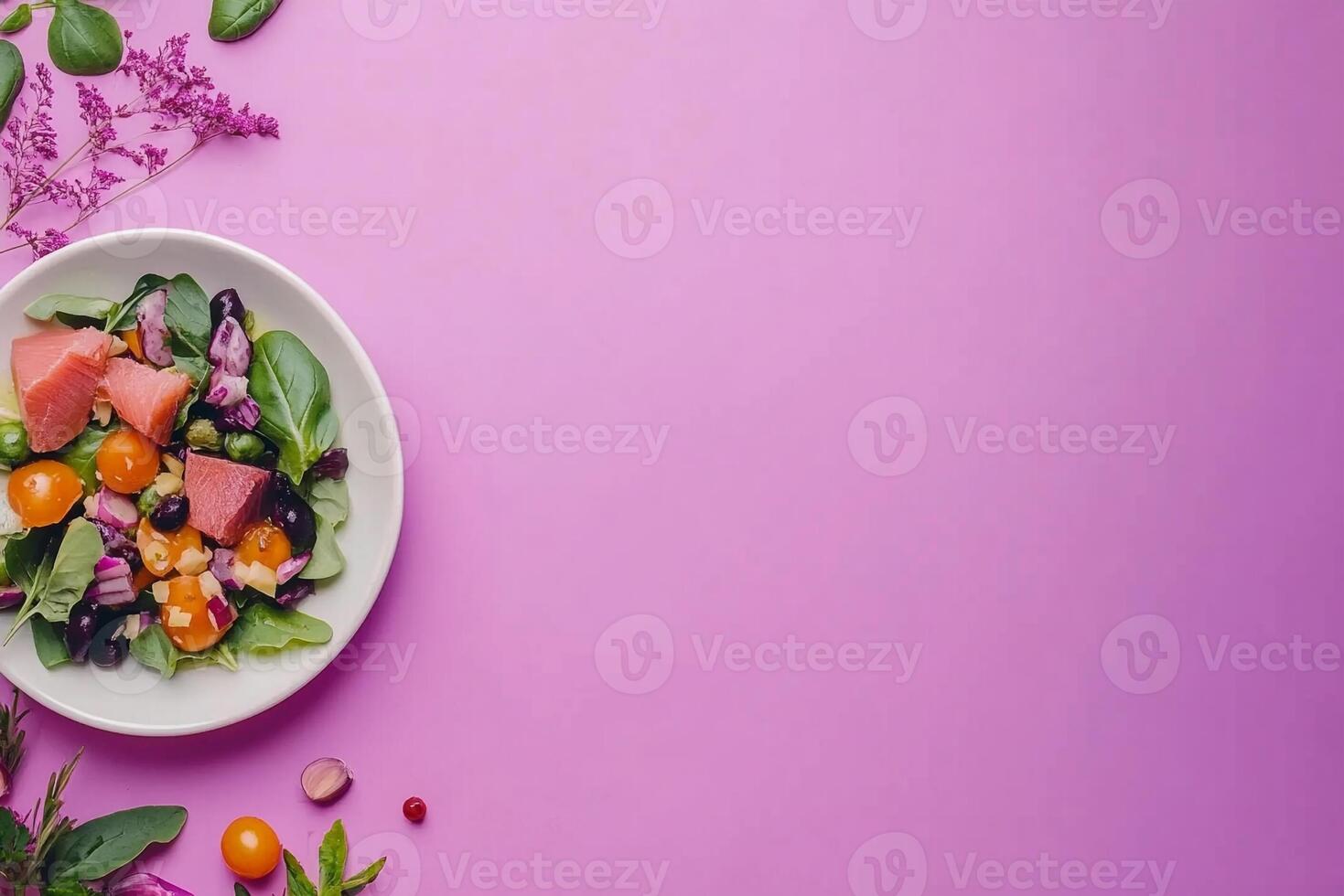 A plate of salad with vegetables and fruit on a purple background photo