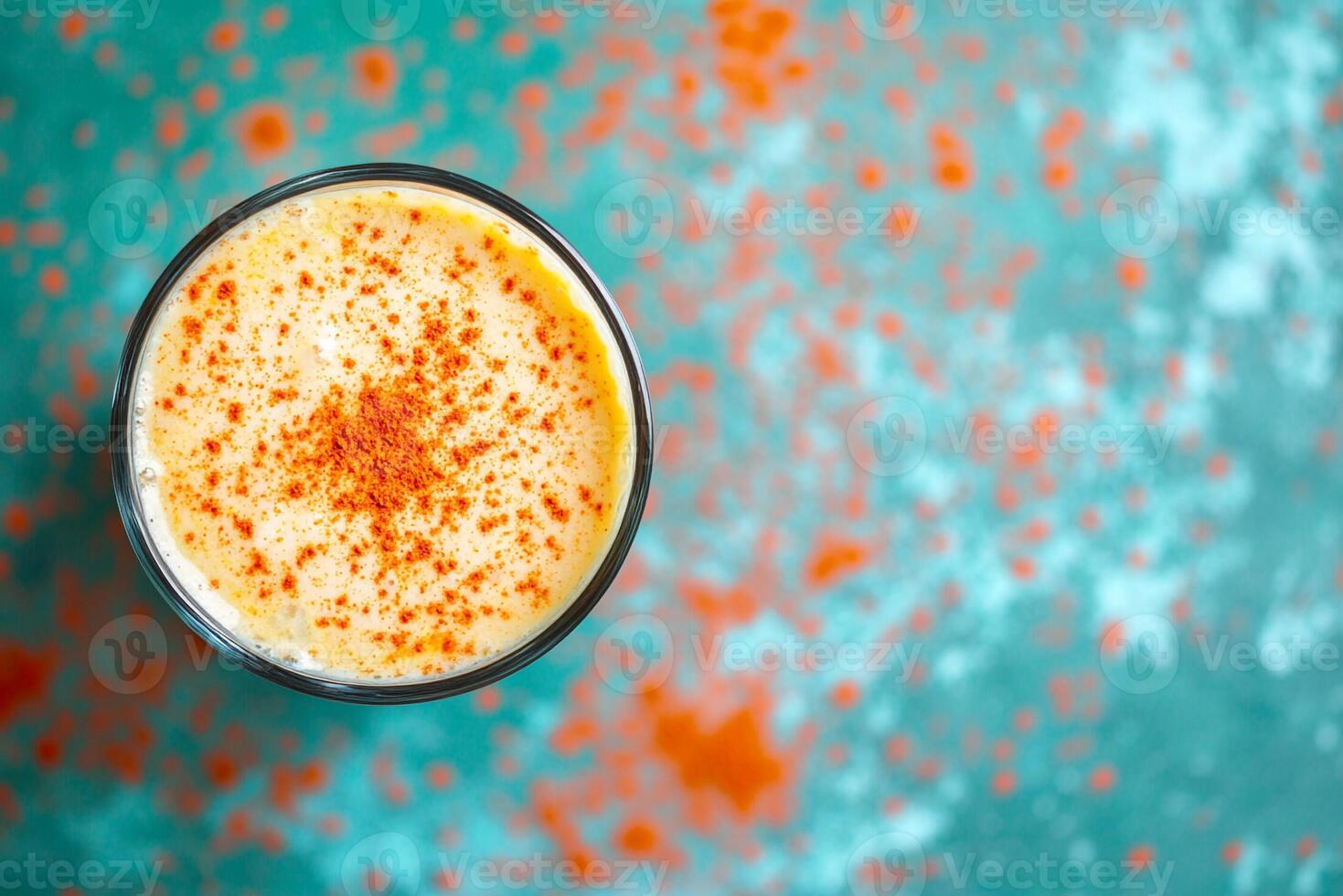 A glass of orange juice on a blue background photo