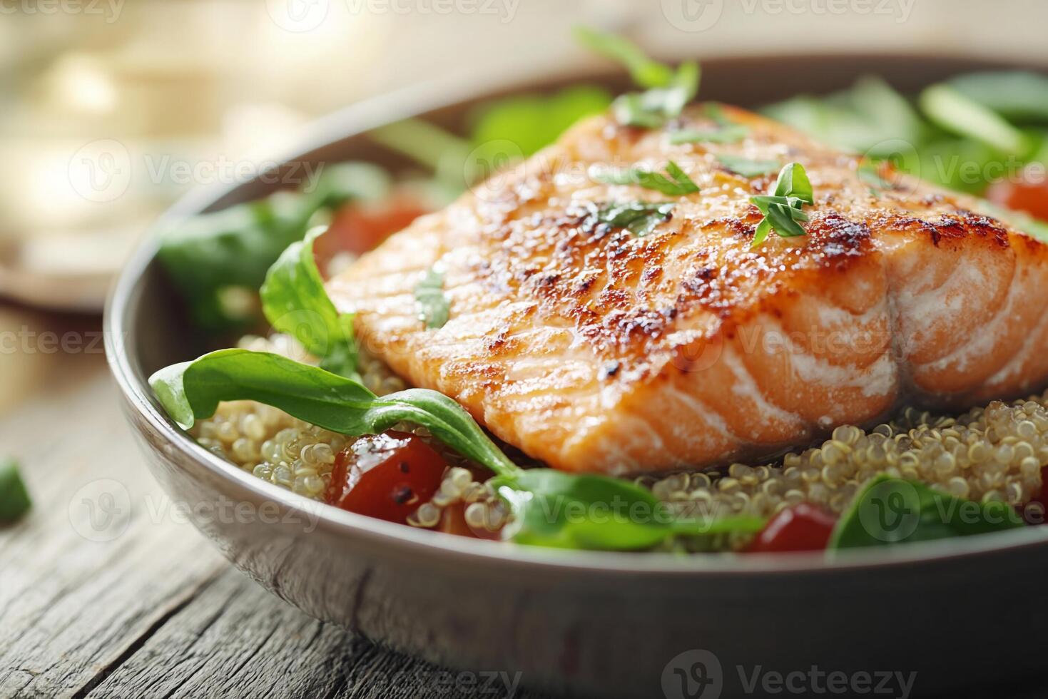 Salmon with quinoa and spinach in a bowl photo