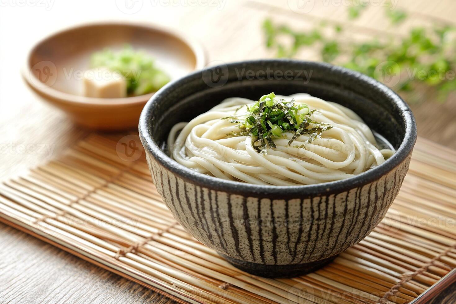 Soy sauce noodles in a bowl on a bamboo mat photo
