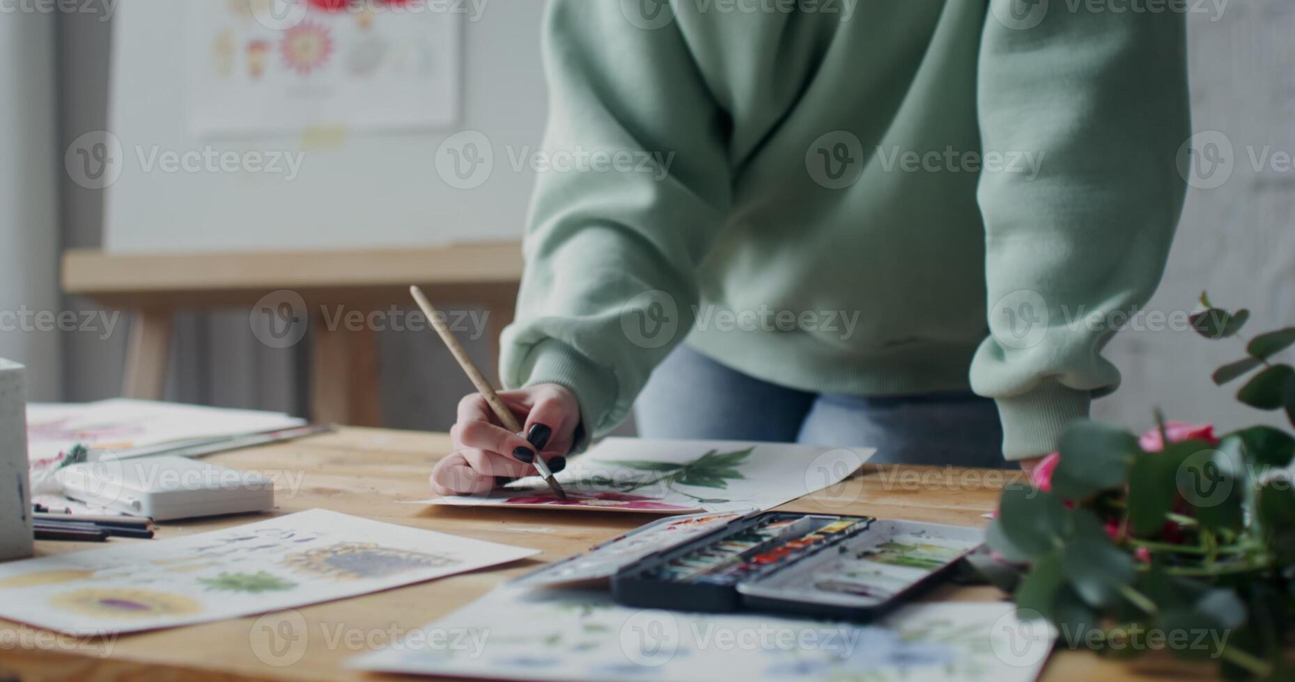 Young woman artist in sportswear draws flowers photo