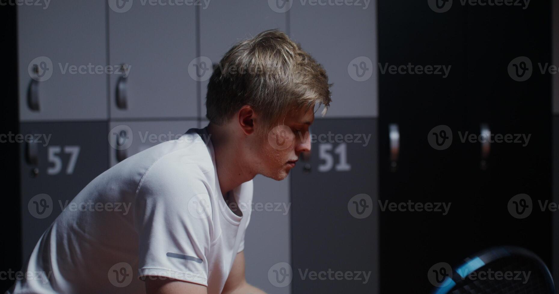 Young handsome male tennis player resting photo