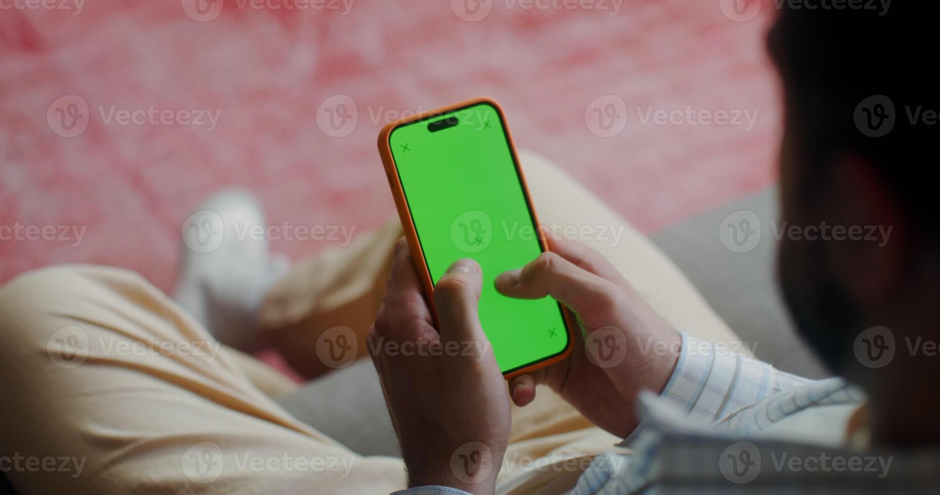 A man in casual clothes typing on a mobile phone photo