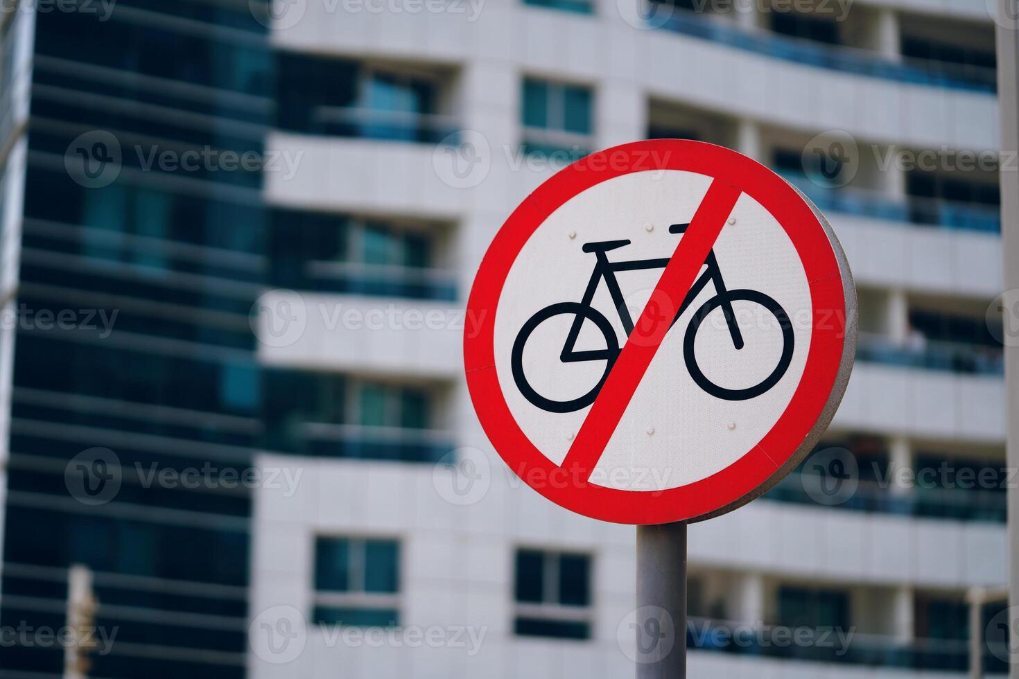 A traffic sign featuring a crossedout bicycle symbol is displayed in front of the building, indicating bicycles are not permitted on the premises photo