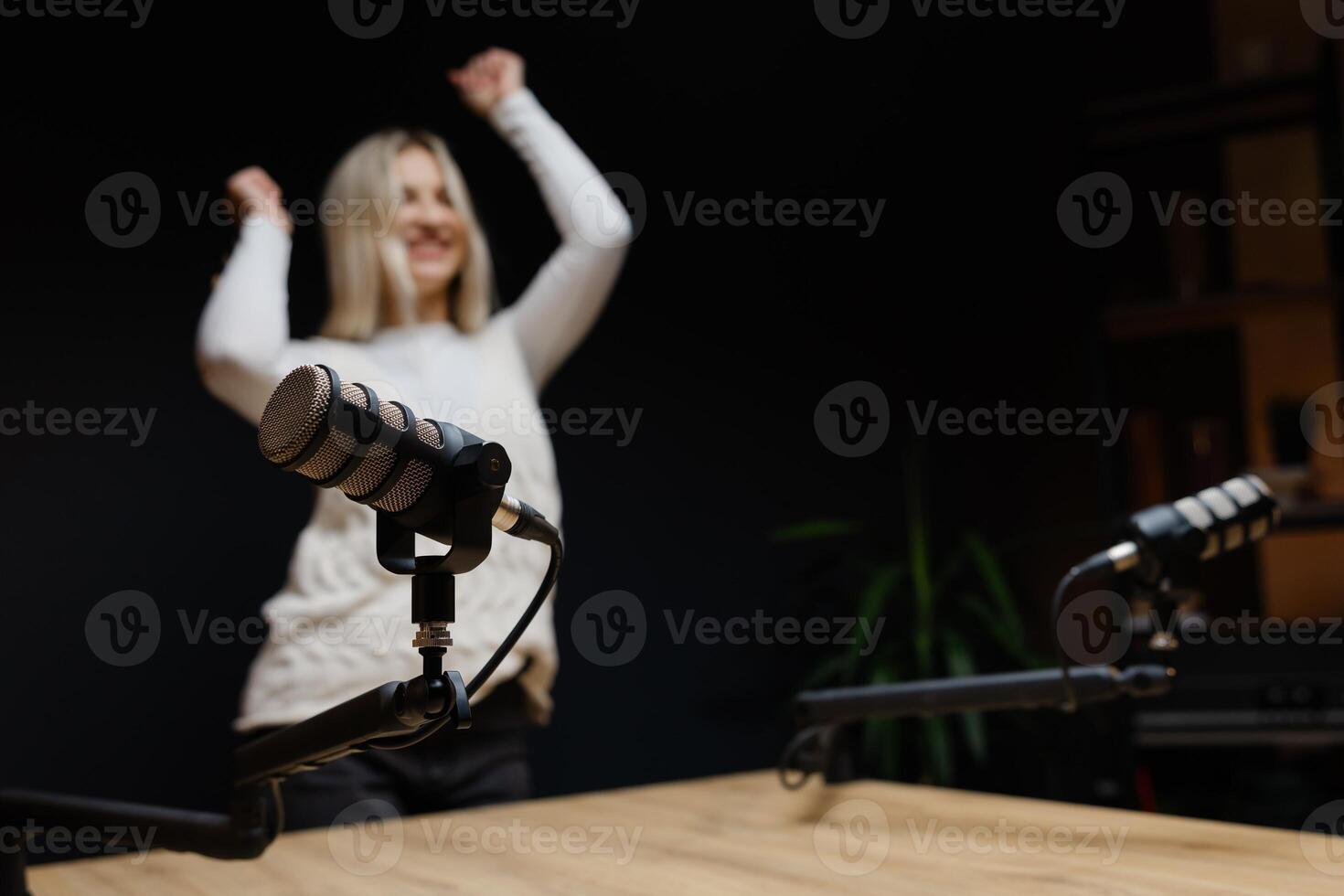 Podcaster dancing and laughing during a recording session. photo