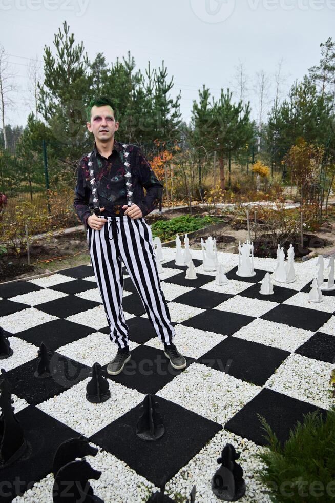 A Whimsical Gardener Playing on a Giant Colorful Chessboard with Unique Artistic Concepts photo