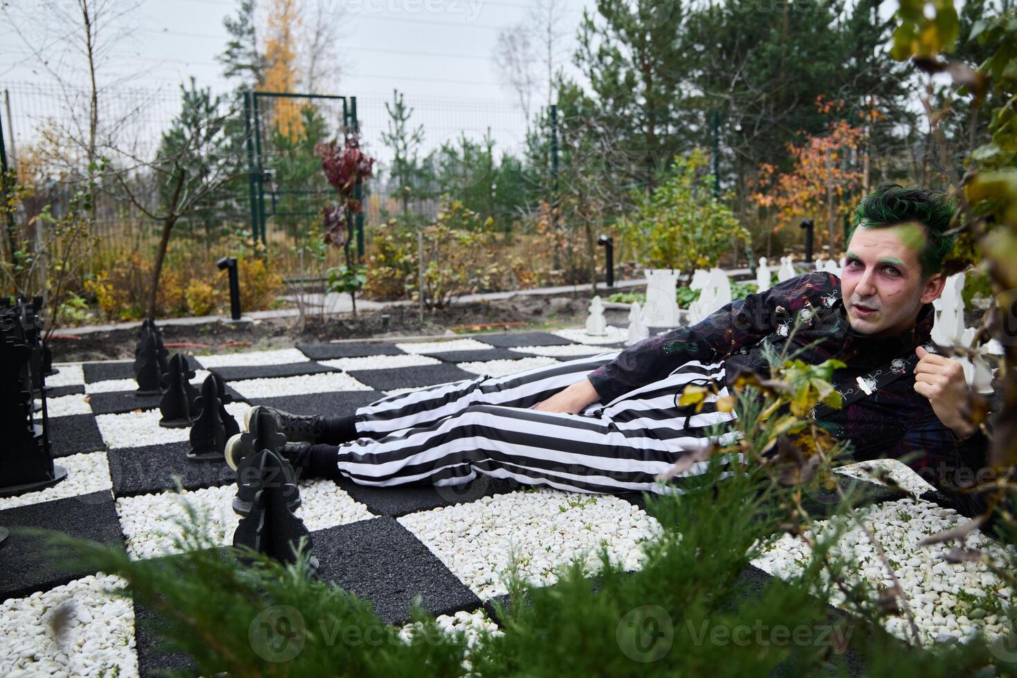 A Creative Chess Themed Photoshoot Taking Place in the Beautiful Outdoors of Nature photo