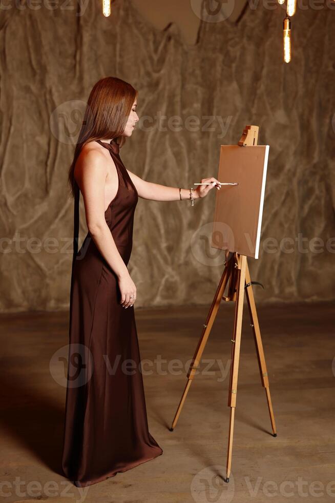 An Elegant Woman Engaged in Painting on Canvas, Set Within a Chic and Stylish Environment photo