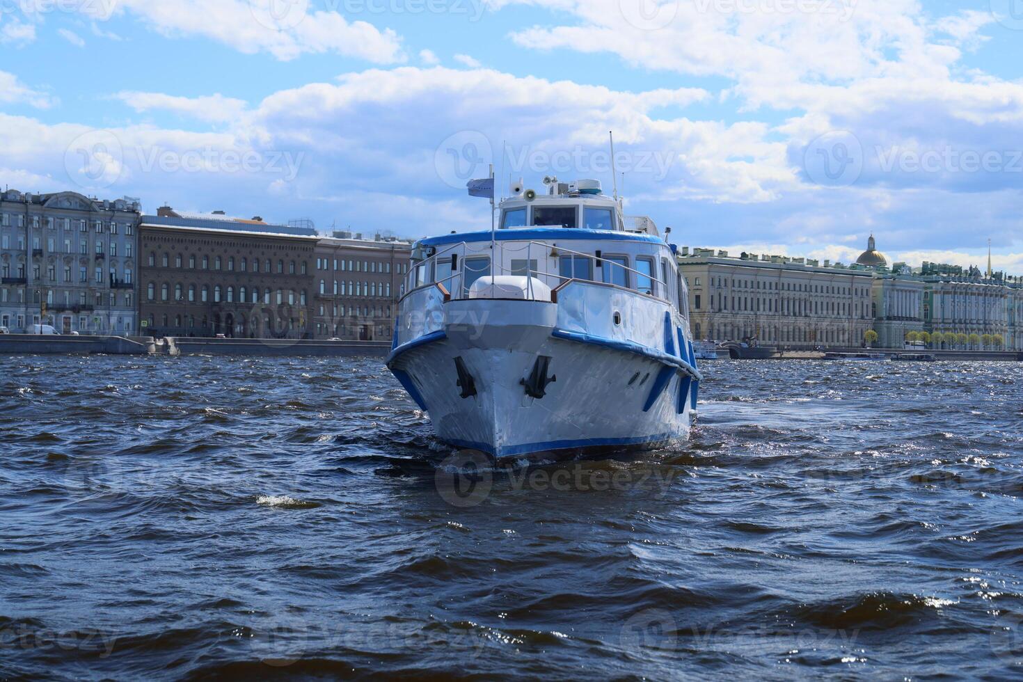 A boat gliding across tranquil water with historic buildings majestically in the background photo