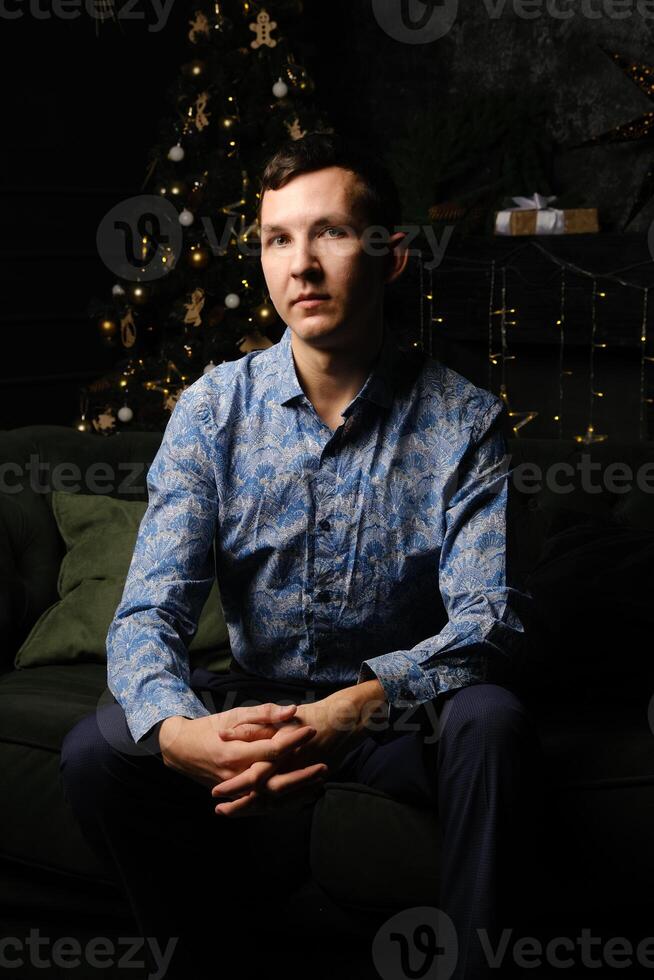 An Elegant Man Posing Confidently in His Stylish and Fashionable Attire While Relaxing photo