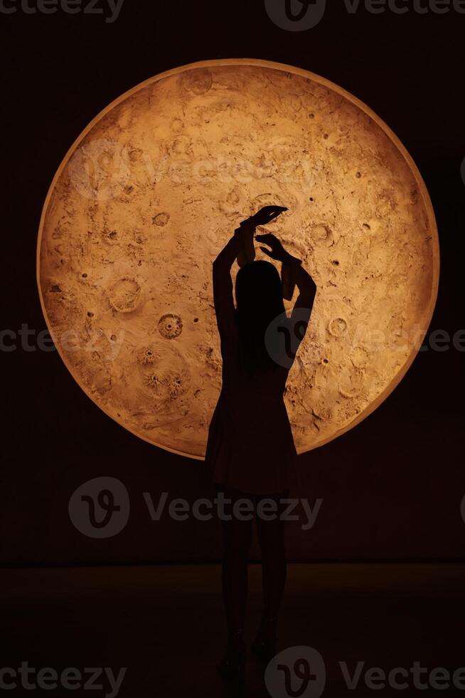 The Silhouette of Hands is posed against a Glowing Orb, enhancing atmosphere and appeal photo