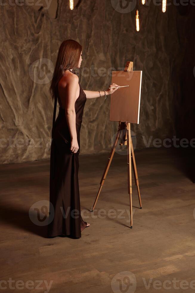 An Elegant Artist Engaged in Creative Work Within a Timeless and Inspiring Studio Setting photo