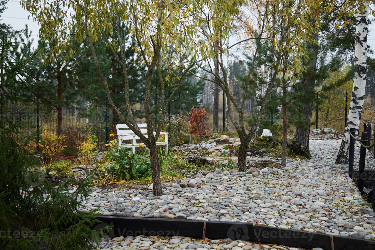 A Tranquil Autumn Garden featuring beautifully designed Pathways and comfortable Seating photo