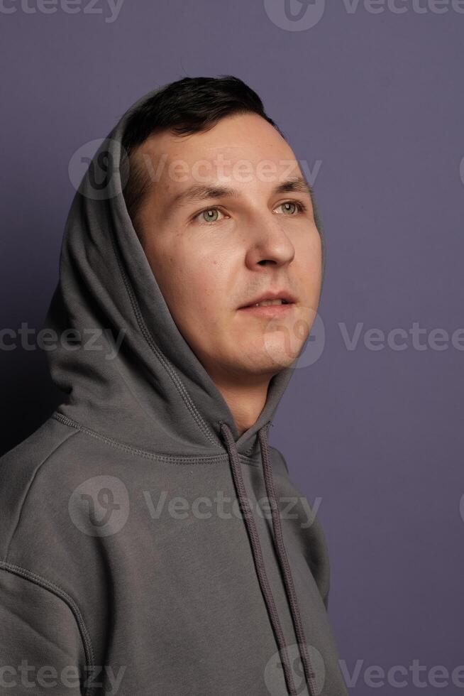A Casual Portrait Depicting a Young Man Styled in a Comfortable and Relaxed Hoodie photo