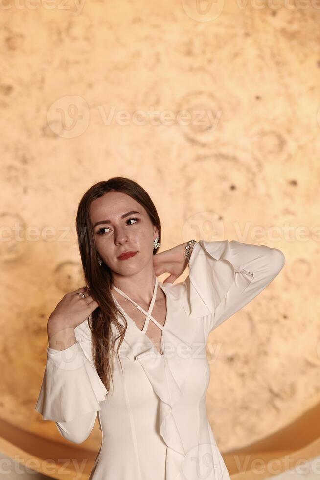 A Chic Woman Posing Elegantly Against a Beautifully Textured and Visually Appealing Background photo