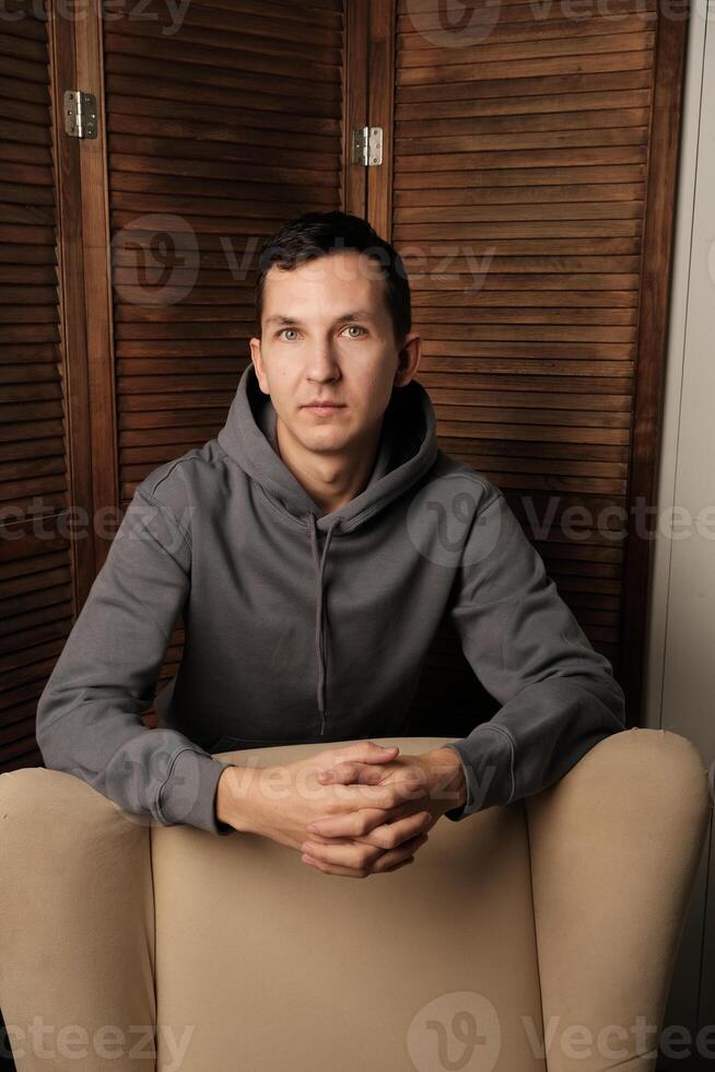 A Contemplative Portrait Set in a Modern Environment with Various Artistic Elements photo