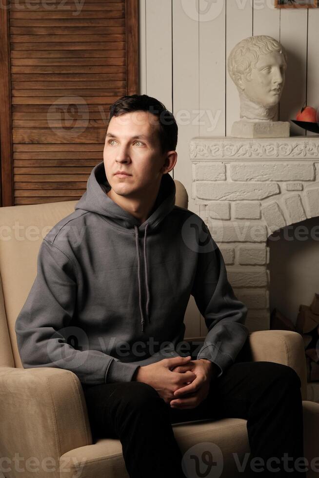 A Thoughtful Individual Dressed in Casual Attire with an Artistic Background and Vibe photo