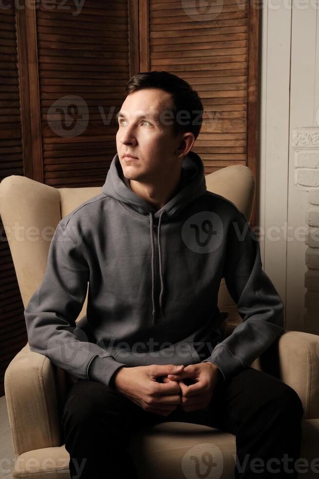A Contemplative Young Man Finds Tranquility in a Cozy and Inviting Setting at Home photo
