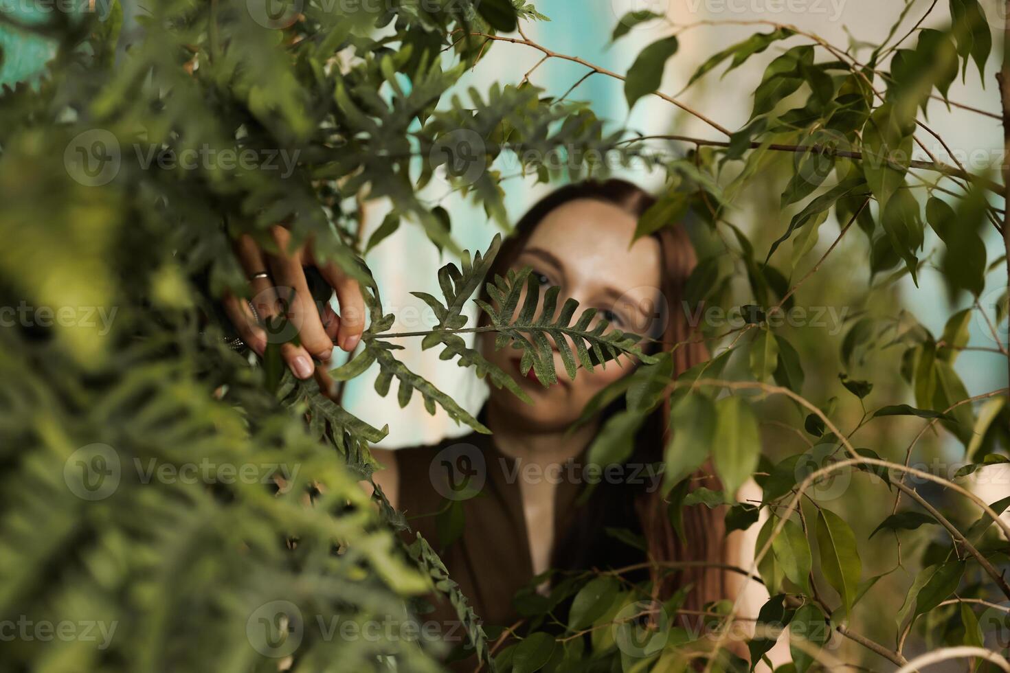 A woman beautifully enveloped in greenery, surrounded by natures warm embrace, creates serenity photo