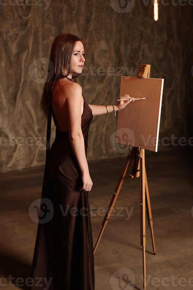 An Elegant Woman Painting in a Beautiful Artistic Studio Setting with a Creative Atmosphere photo