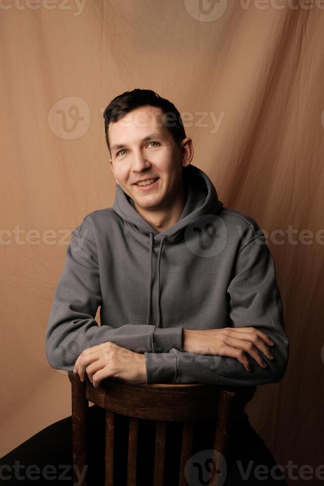 Casual Portrait of a Young Man Wearing a Stylish Hoodie in a Comfortable Setting photo