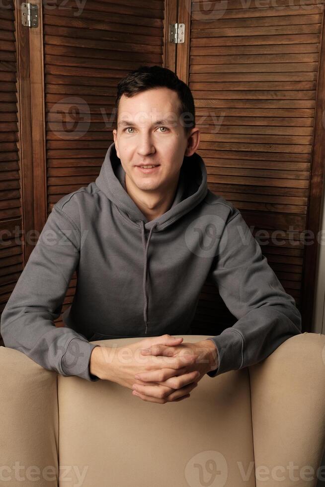 A Casual Portrait of a Young Man in a Casual Hoodie, Reflecting His Unique Style and Attitude photo
