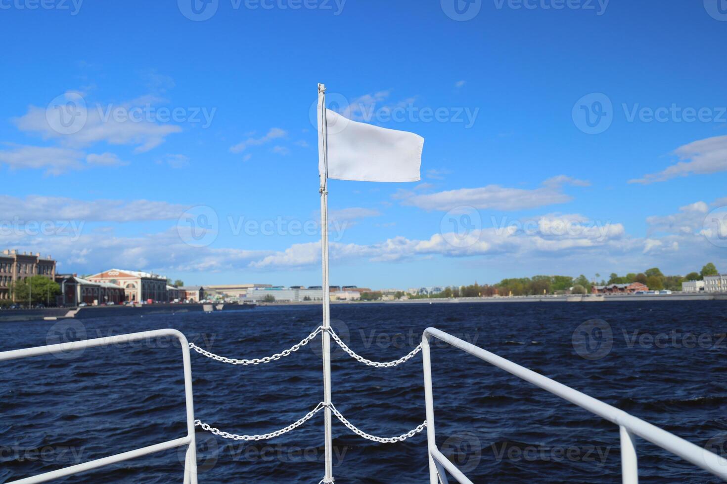 A Serene River Journey unfolds under Cloudy Skies, highlighted by a White Flag fluttering gently photo