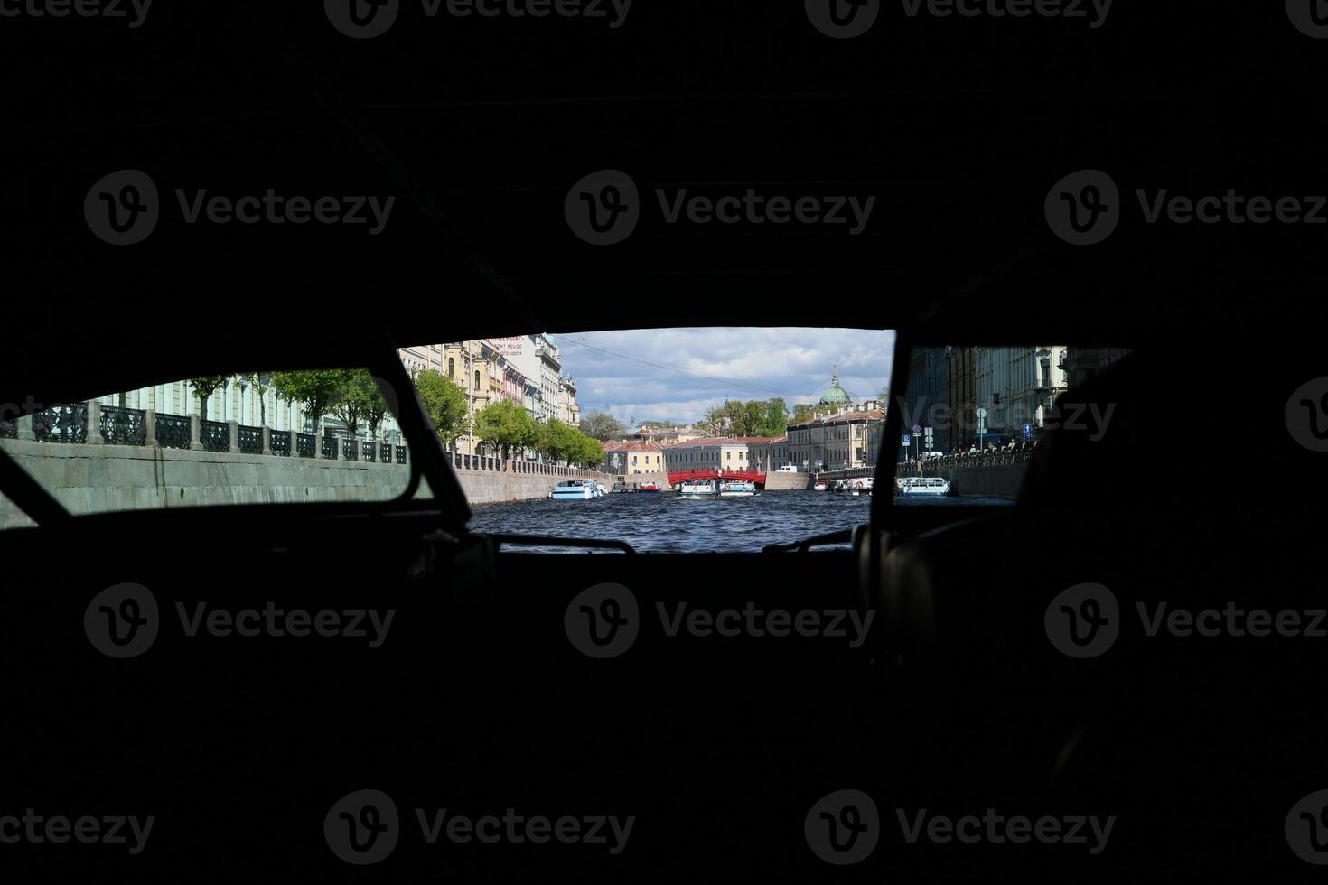 A stunning cityscape view from inside a vehicle traveling along a picturesque waterway photo