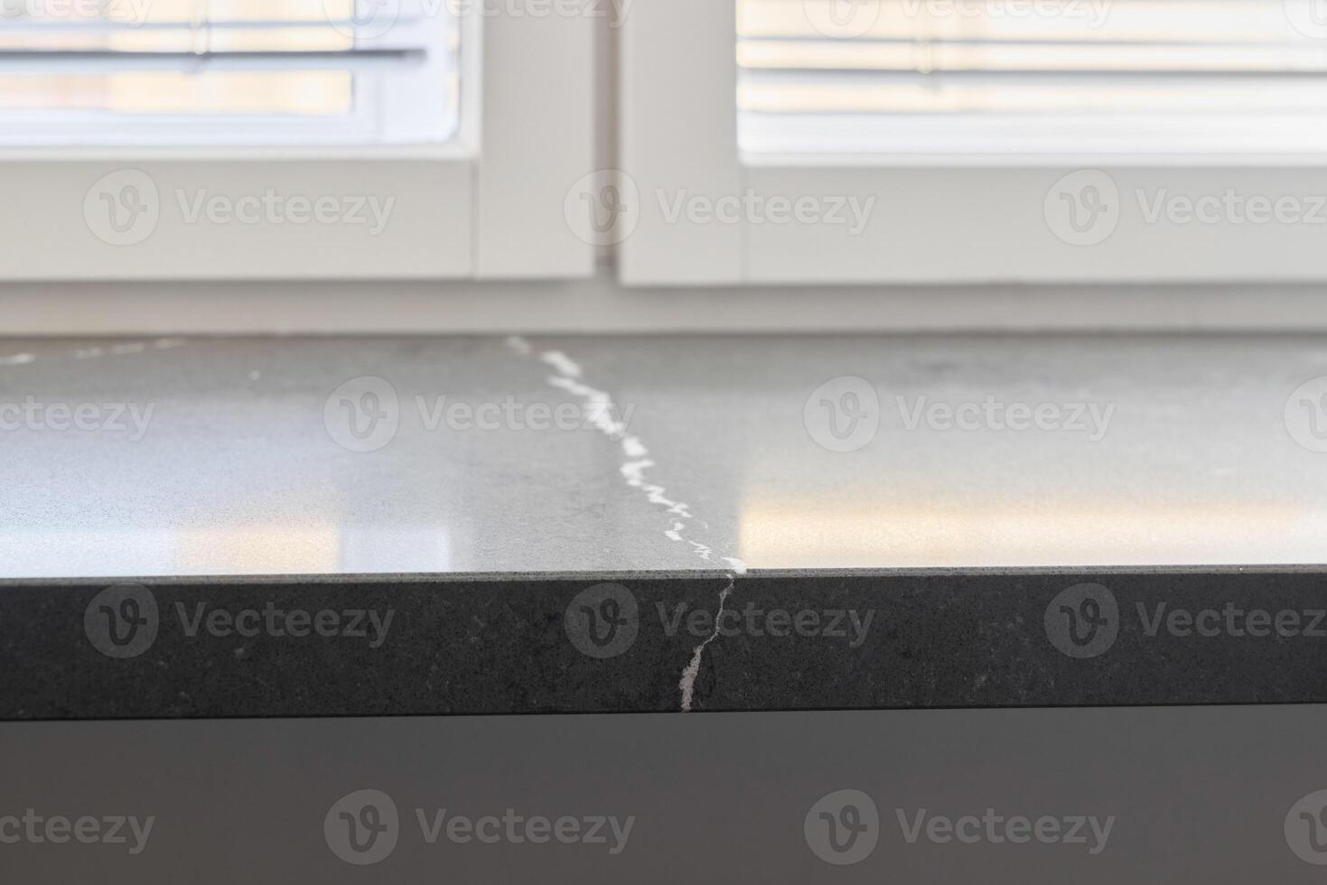 An Elegant Dark Stone Surface that Features Beautiful Natural Veining Patterns Throughout photo