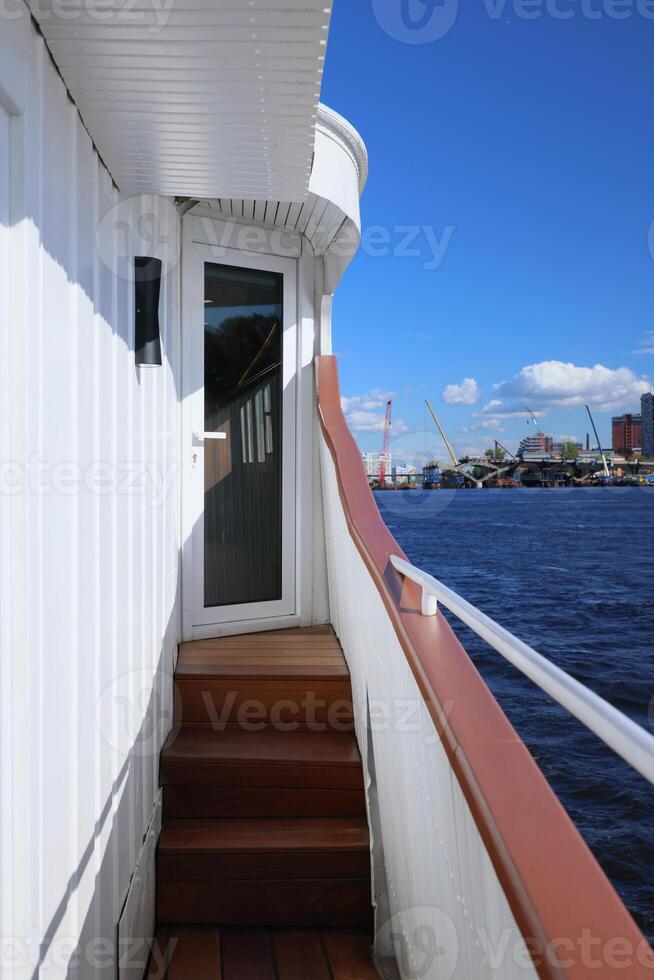 Enjoy a breathtaking waterfront view from the steps of a boat for an unforgettable experience photo