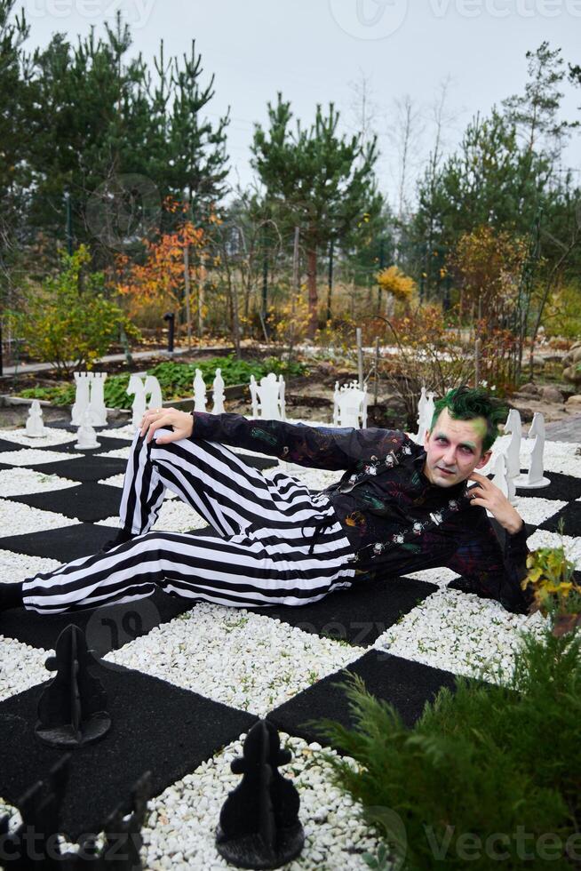 A Fashionable Chessboard Pose in Stylish Striped Attire Set Against a Beautiful Background photo