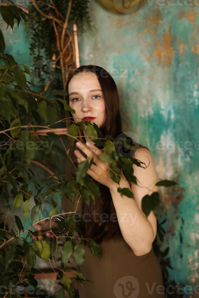 An Elegant Woman Surrounded by Lush Greenery with a Beautiful and Artistic Background photo